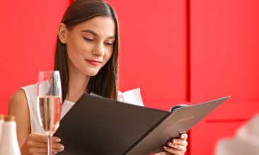 Woman reading a menu at a restaurant.